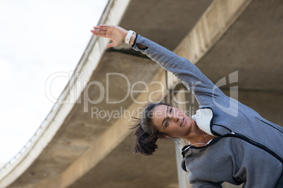 Fit woman doing stretching exercise