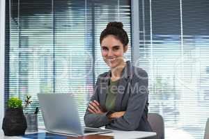 Portrait of confident female executive sitting at desk