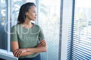 Female executives looking through window in office