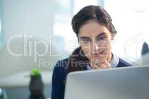 Thoughtful female executive working on computer