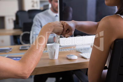 Executive sharing success with fist bumping