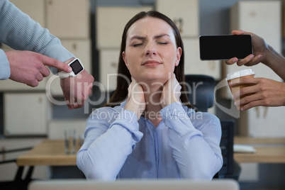 Colleague showing time and mobile phone to frustrated woman