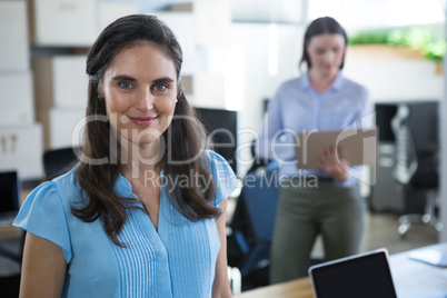 Female executive looking into camera in the office