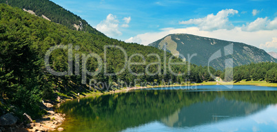 Picturesque lake, mountains and blue sky.