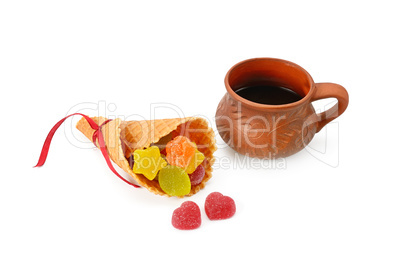 Coffee cup and marmalade candies isolated on white background.