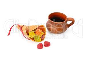 Coffee cup and marmalade candies isolated on white background.