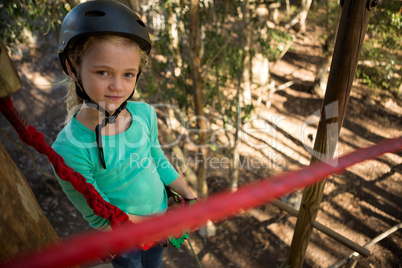 Little girl wearing helmet standing in the forest