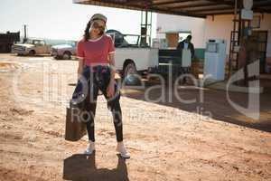 Woman holding a petrol can at petrol pump