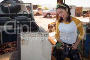 Woman filling petrol in car at petrol pump