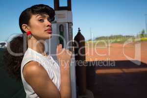 Woman relaxing at petrol pump station