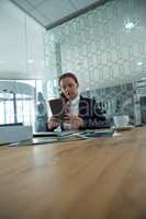 Female executive using digital tablet at desk