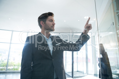 Businessman touching invisible digital screen