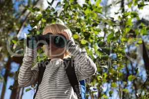Little girl looking through binoculars