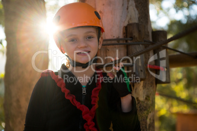 Portrait of beautiful little girl wearing helmet in the forest