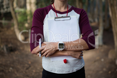 Woman folding hands holding writing pad in her arms