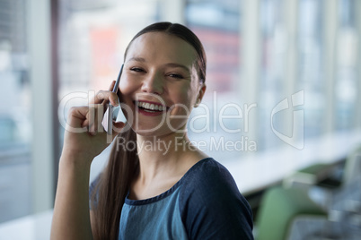 Portrait of female executive talking on mobile phone