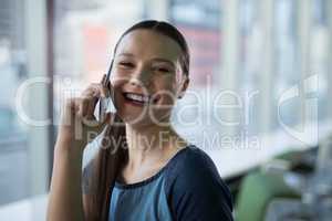 Portrait of female executive talking on mobile phone