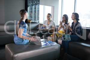 Executives applauding colleague during presentation