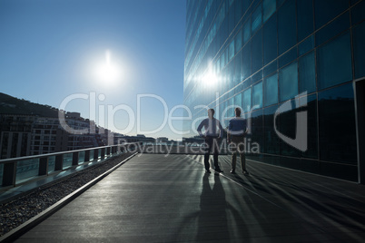 Male executives walking together in office premises