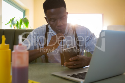 Man using mobile phone while having drinks