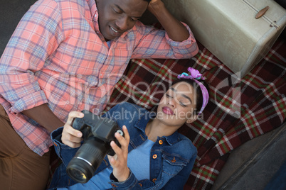 Couple looking at pictures on camera