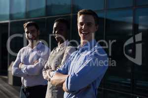 Portrait of male and female executives standing in office premises