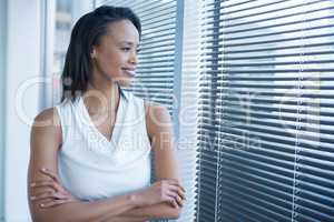 Female executives looking through window in office