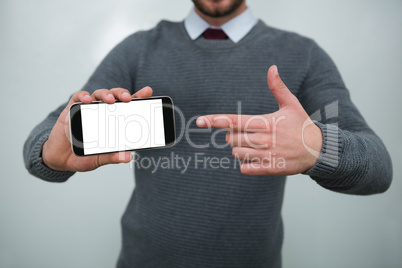 Executive showing mobile phone in the office