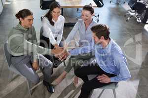 Group of executives stacking hands over each other