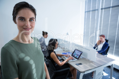 Beautiful female executive looking at camera