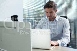 Young executive man using his laptop