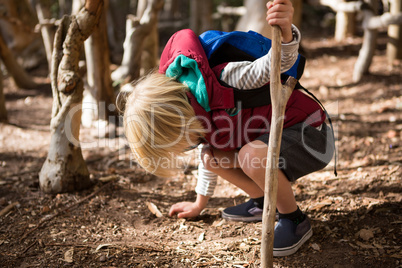 Little girl with stick touching ground