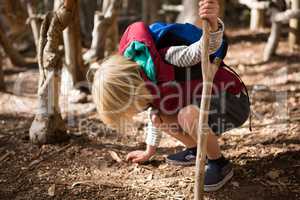 Little girl with stick touching ground