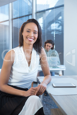 Portrait of female executive sitting at desk