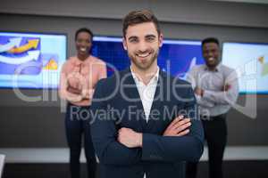 Portrait of confident executives standing with arms crossed