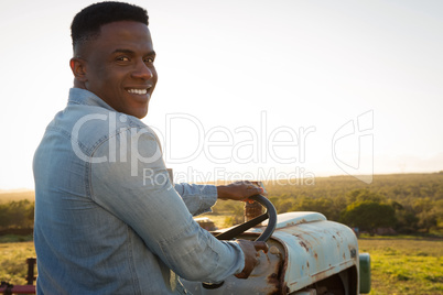 Farmer driving tractor at countryside