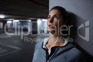 Tired woman leaning on pillar