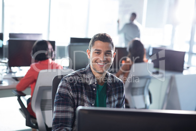 Male executive working on personal computer in office