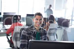Male executive working on personal computer in office