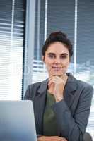 Portrait of confident female executive sitting at desk