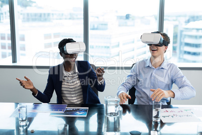 Smiling executives using virtual reality headset