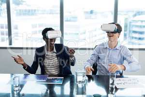 Smiling executives using virtual reality headset