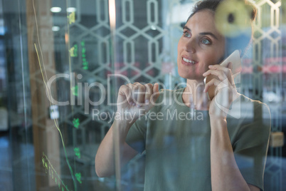 Female executive talking on mobile phone