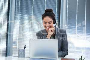Female executive doing video call on laptop