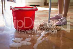 Waitress cleaning floor in restaurant