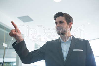 Businessman touching invisible digital screen