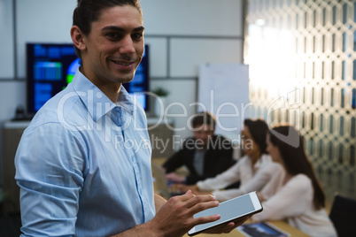 Male executive using digital tablet in conference room