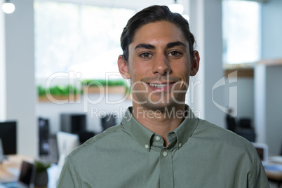 Male executive looking at camera in the office