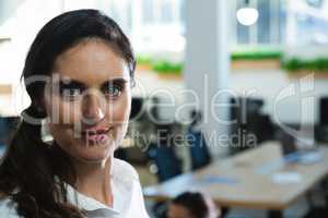 Beautiful female executive looking at camera