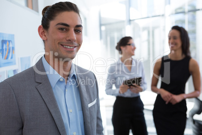 Male executive looking at camera in the office